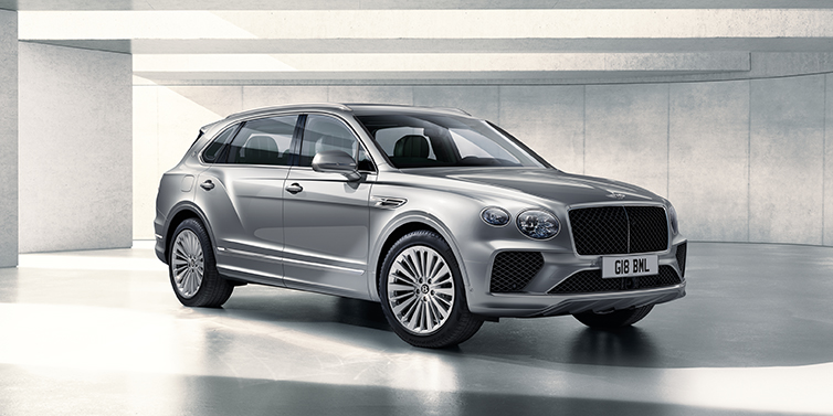 Bentley Tel Aviv Bentley Bentayga Extended Wheelbase SUV front three quarter in Moonbeam paint with a grey background