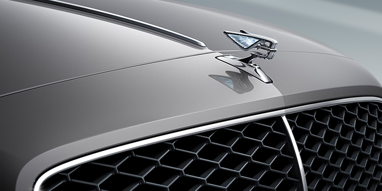 Bentley Tel Aviv New Bentley Flying Spur sedan bonnet detail in Silverlake paint with Illuminated Flying B bonnet badge and matrix grille with chrome surround