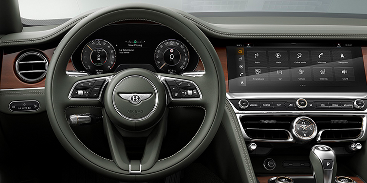 Bentley Tel Aviv New Bentley Flying Spur front cabin interior in Cumbrian green hide with Crown Cut walnut veneer showing steering wheel and driver controls