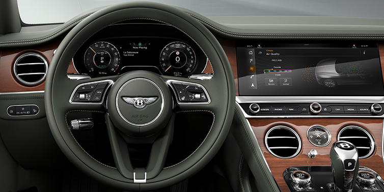 Bentley Tel Aviv New Bentley Continental GT coupe steering wheel and front cabin view in Cumbrian Green hide and Crown Cut walnut veneer